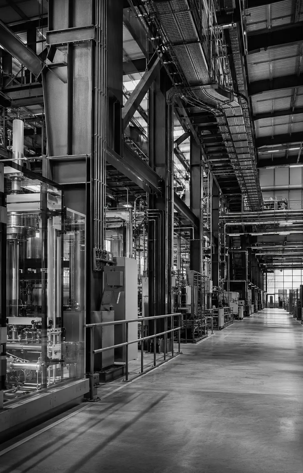 Monochrome view through the steel structure and precision equipment of a modern industrial plant